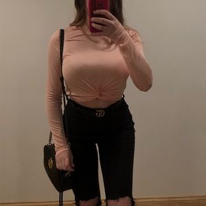 Long sleeve crop top with twist bottom detail.